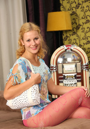 Blonde dancer exposes her enhanced breasts wearing shiny pantyhose